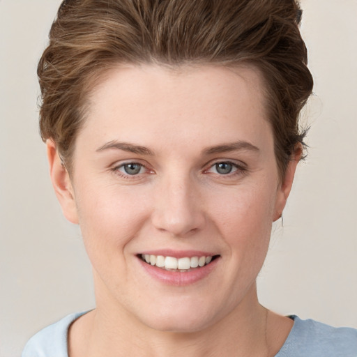 Joyful white young-adult female with short  brown hair and grey eyes