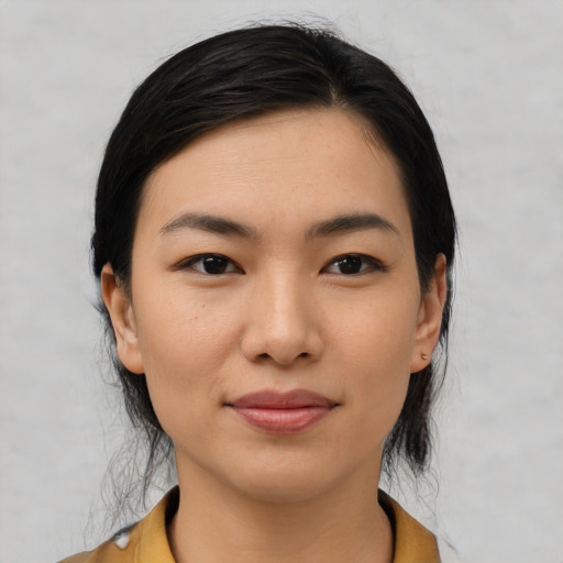 Joyful latino young-adult female with medium  black hair and brown eyes