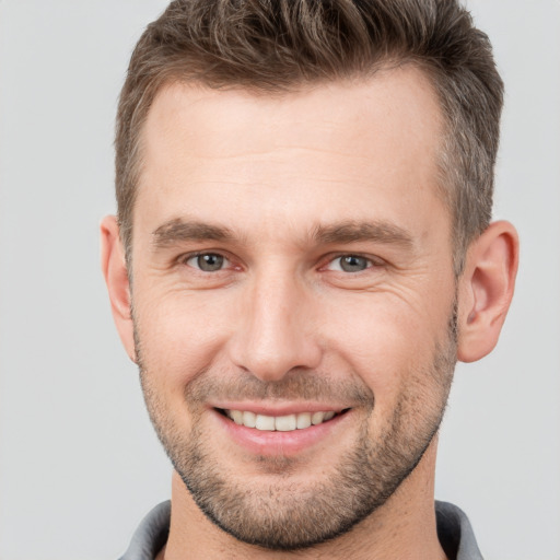 Joyful white young-adult male with short  brown hair and brown eyes