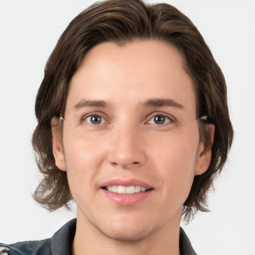 Joyful white young-adult male with medium  brown hair and brown eyes