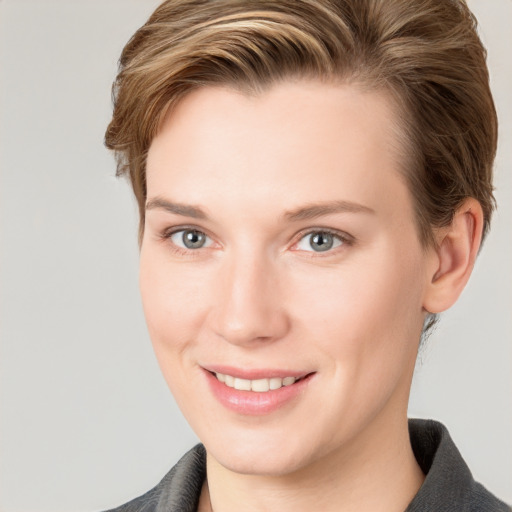 Joyful white young-adult female with short  brown hair and grey eyes