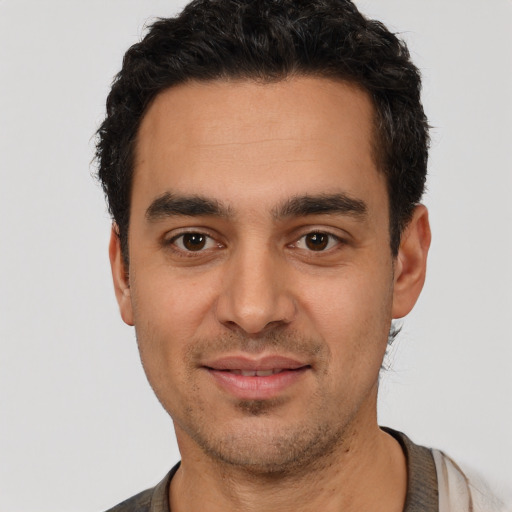 Joyful white young-adult male with short  black hair and brown eyes