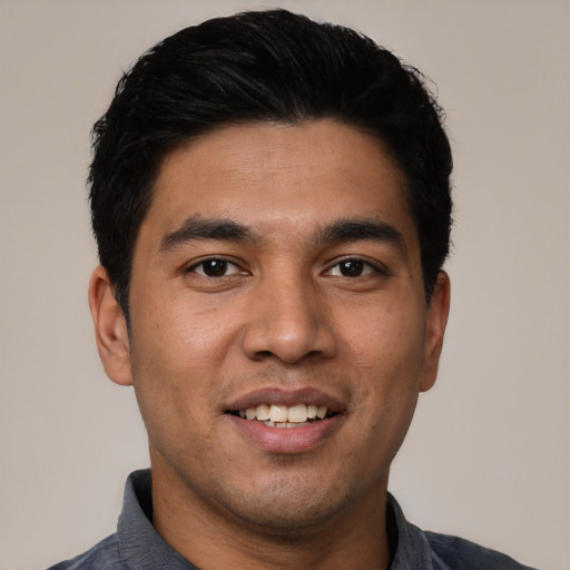 Joyful latino young-adult male with short  black hair and brown eyes