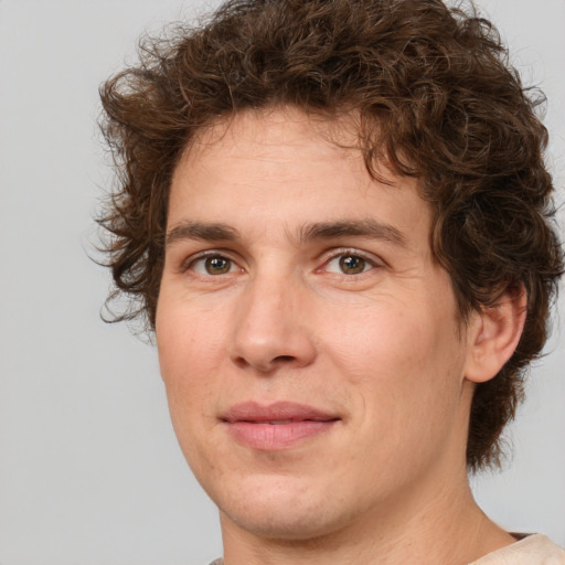 Joyful white young-adult male with medium  brown hair and brown eyes