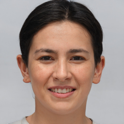 Joyful white young-adult female with short  brown hair and brown eyes