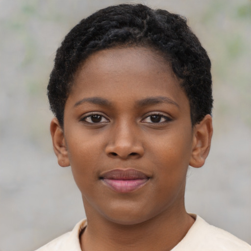 Joyful black child female with short  brown hair and brown eyes