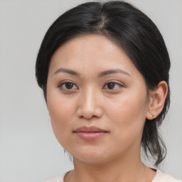 Joyful asian young-adult female with medium  brown hair and brown eyes