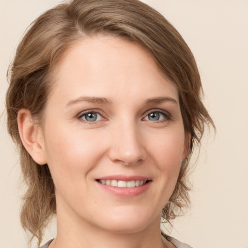 Joyful white young-adult female with medium  brown hair and green eyes