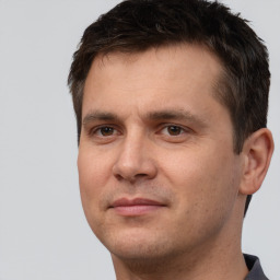 Joyful white adult male with short  brown hair and brown eyes