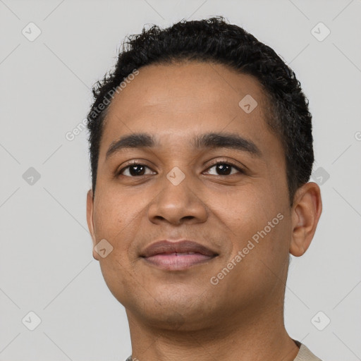 Joyful latino young-adult male with short  black hair and brown eyes