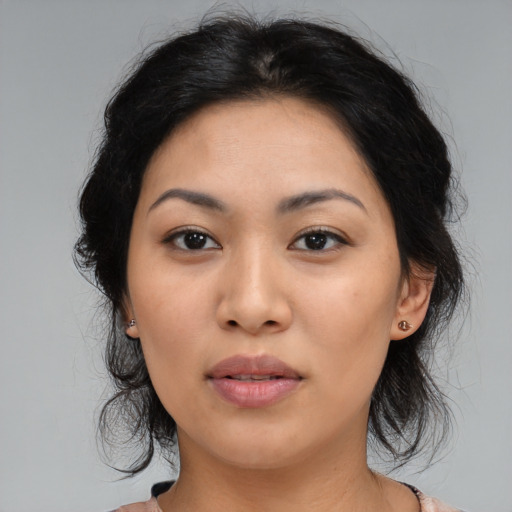 Joyful asian young-adult female with medium  black hair and brown eyes