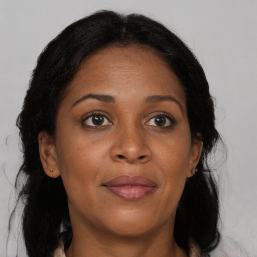 Joyful black adult female with medium  brown hair and brown eyes