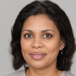 Joyful black adult female with medium  brown hair and brown eyes