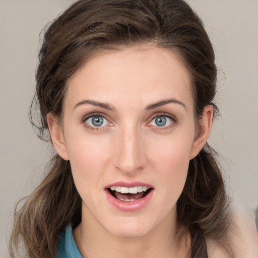 Joyful white young-adult female with medium  brown hair and blue eyes