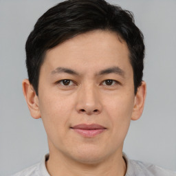 Joyful asian young-adult male with short  brown hair and brown eyes