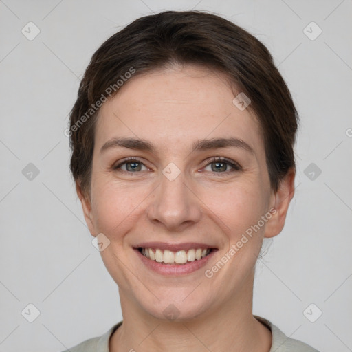 Joyful white young-adult female with short  brown hair and grey eyes