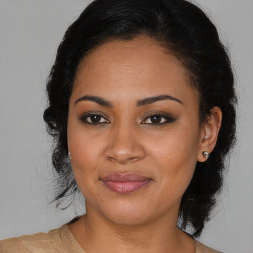 Joyful black young-adult female with medium  brown hair and brown eyes