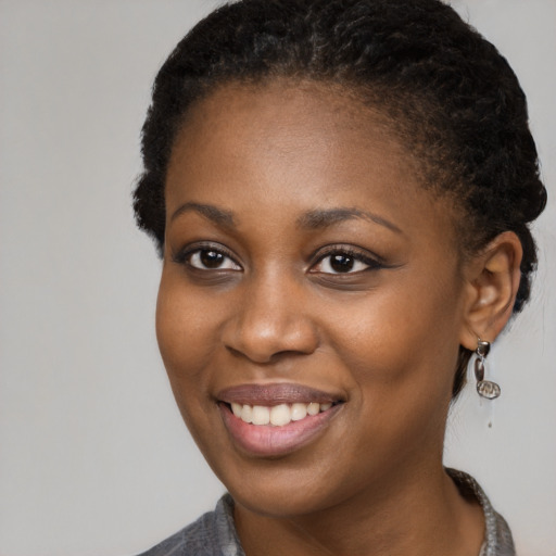 Joyful black young-adult female with medium  brown hair and brown eyes