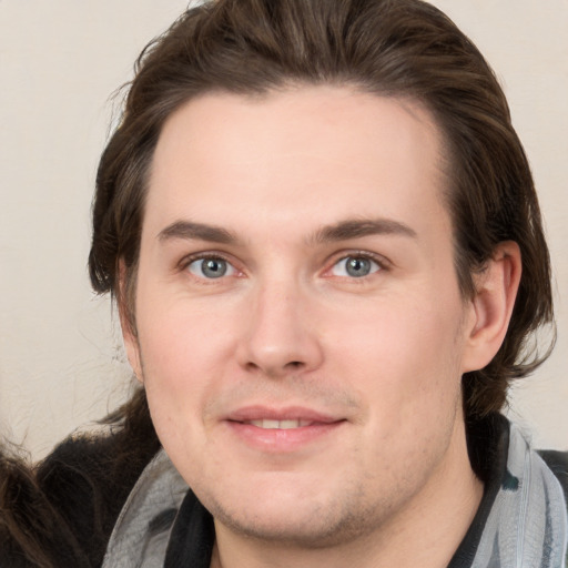 Joyful white young-adult male with medium  brown hair and brown eyes