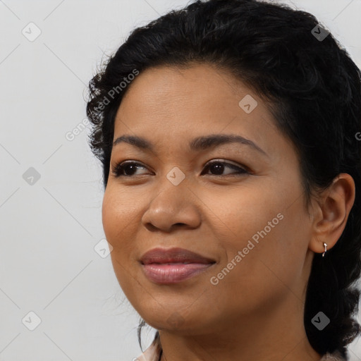 Joyful black young-adult female with medium  black hair and brown eyes