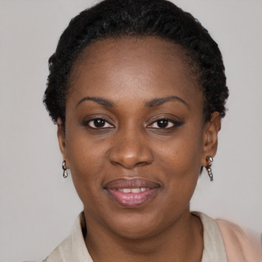 Joyful black young-adult female with short  brown hair and brown eyes