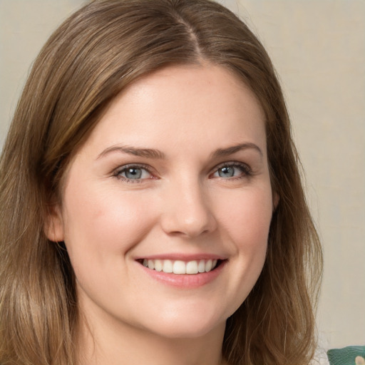 Joyful white young-adult female with medium  brown hair and green eyes