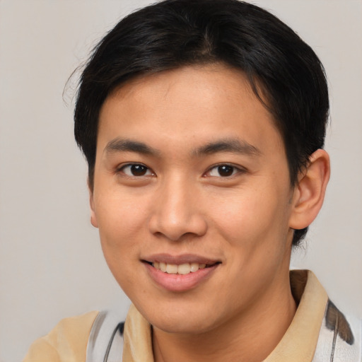 Joyful asian young-adult male with short  brown hair and brown eyes