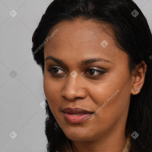 Joyful black young-adult female with long  brown hair and brown eyes