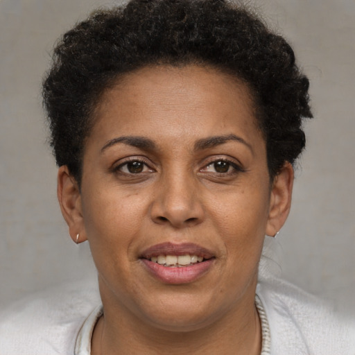 Joyful black young-adult female with short  brown hair and brown eyes
