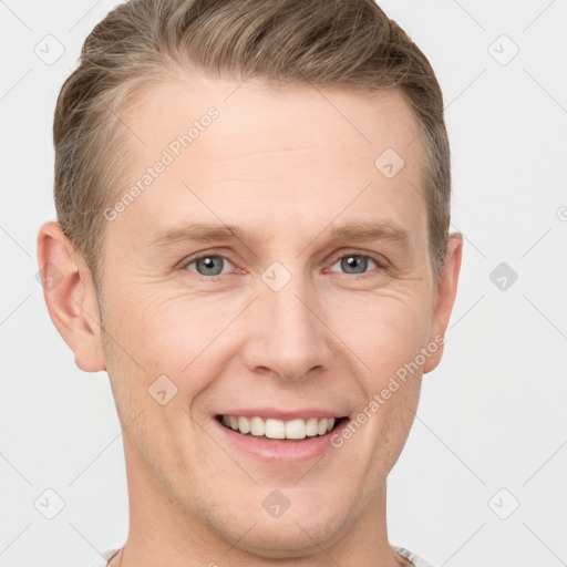 Joyful white adult male with short  brown hair and grey eyes