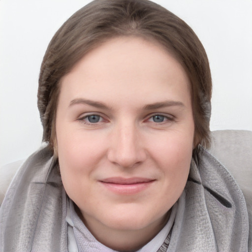 Joyful white young-adult female with medium  brown hair and blue eyes