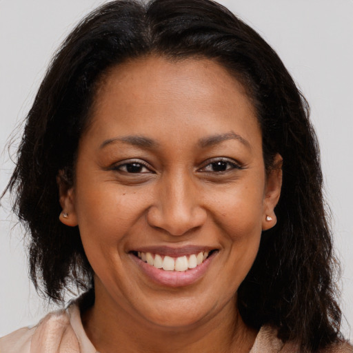 Joyful latino adult female with long  brown hair and brown eyes