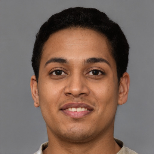 Joyful latino young-adult male with short  brown hair and brown eyes