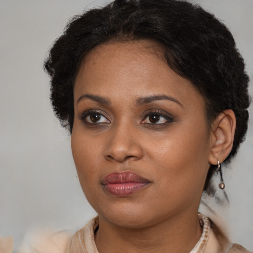 Joyful black young-adult female with medium  brown hair and brown eyes