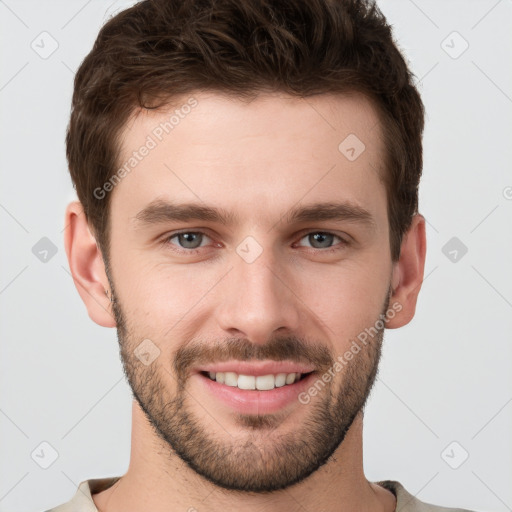 Joyful white young-adult male with short  brown hair and grey eyes