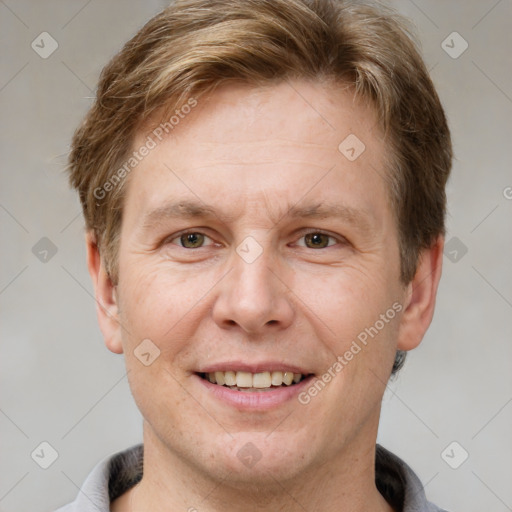 Joyful white adult male with short  brown hair and grey eyes