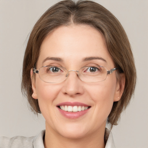 Joyful white adult female with medium  brown hair and grey eyes