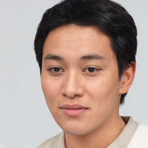 Joyful asian young-adult male with short  black hair and brown eyes