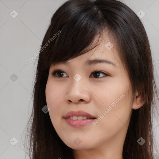 Joyful asian young-adult female with long  brown hair and brown eyes