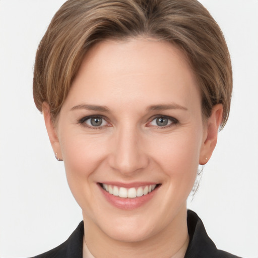 Joyful white young-adult female with medium  brown hair and grey eyes