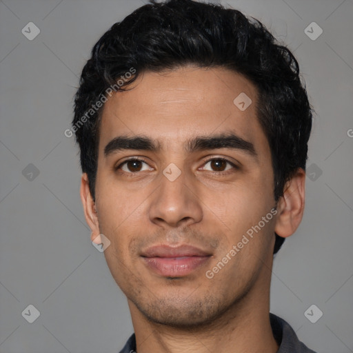 Joyful latino young-adult male with short  black hair and brown eyes