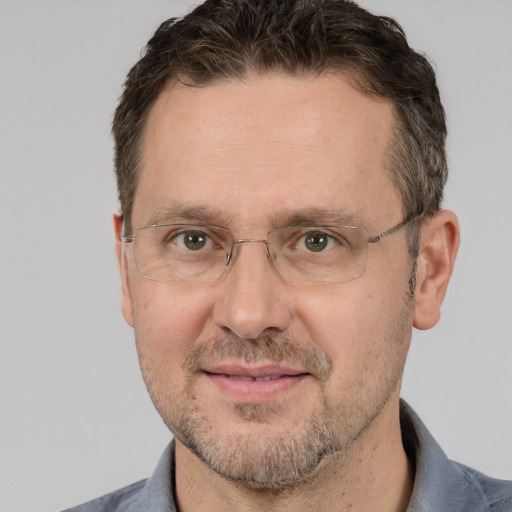 Joyful white adult male with short  brown hair and brown eyes