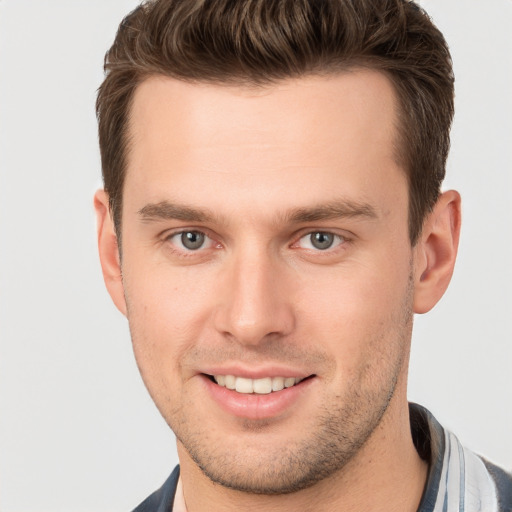 Joyful white young-adult male with short  brown hair and brown eyes