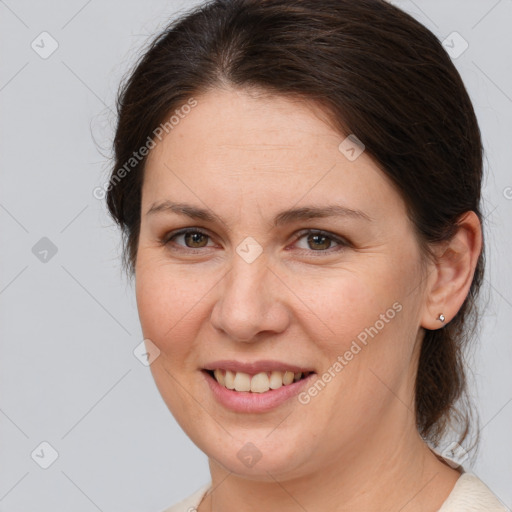 Joyful white adult female with medium  brown hair and brown eyes