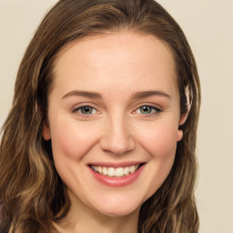 Joyful white young-adult female with long  brown hair and green eyes