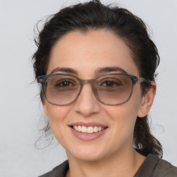 Joyful white adult female with medium  brown hair and brown eyes