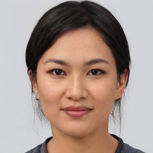 Joyful asian young-adult female with medium  black hair and brown eyes