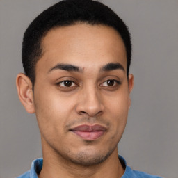 Joyful latino young-adult male with short  brown hair and brown eyes