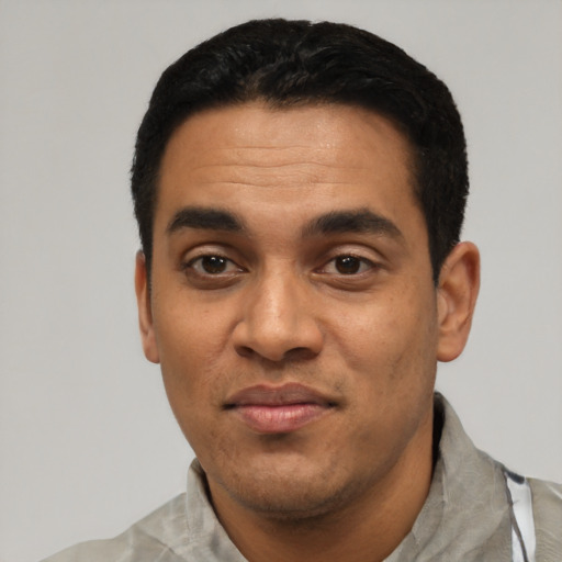 Joyful latino young-adult male with short  black hair and brown eyes