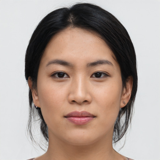 Joyful asian young-adult female with medium  black hair and brown eyes